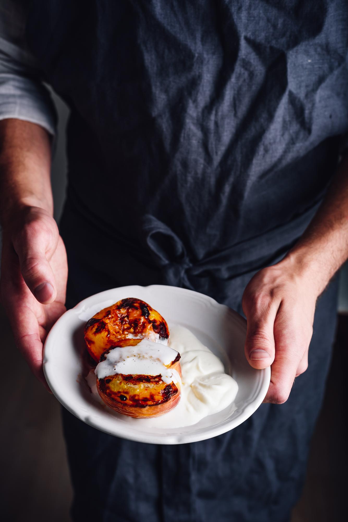 Chef arranging delicate canapé on plate in studio