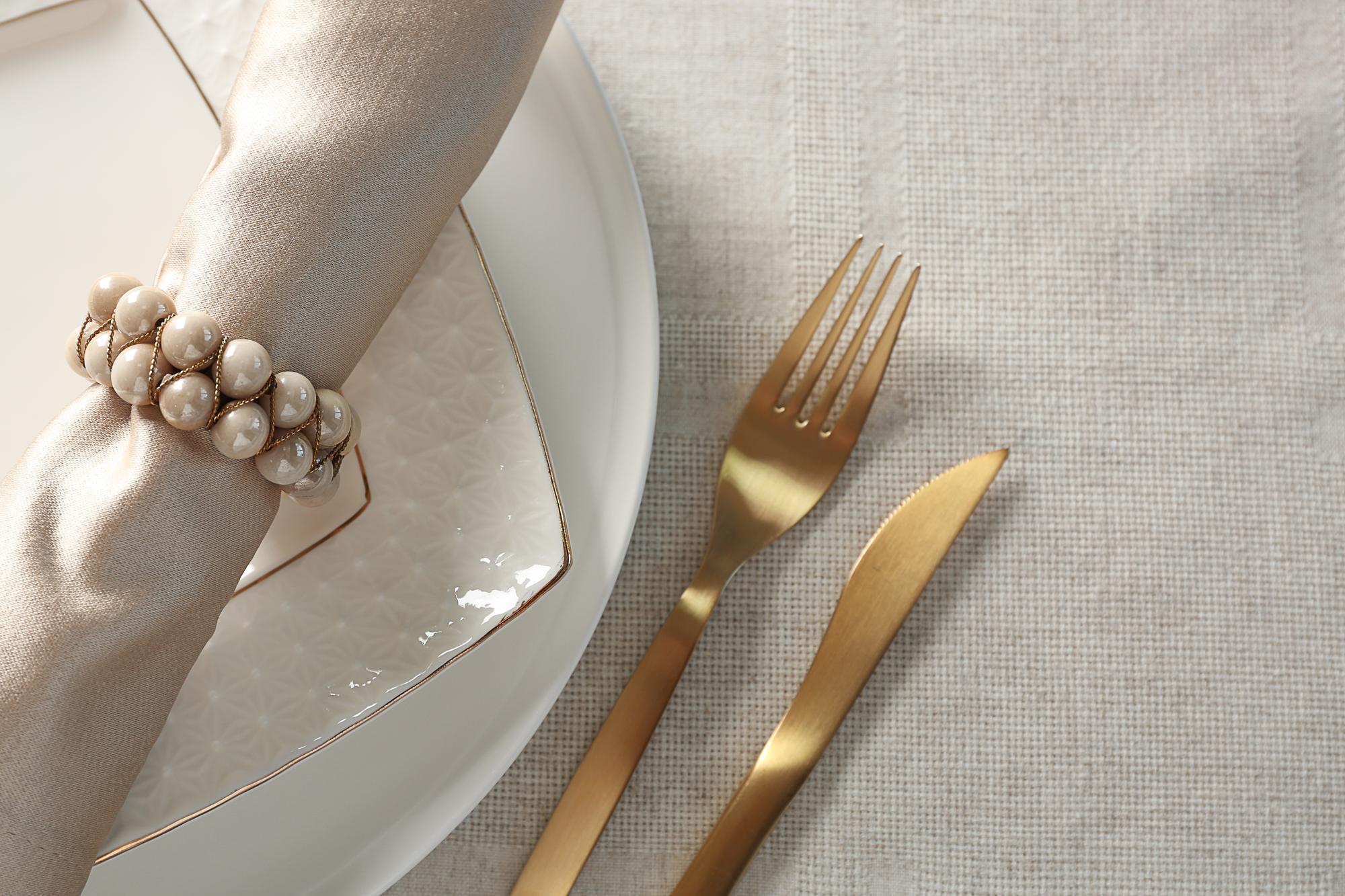 Printed menu and gold cutlery on white table